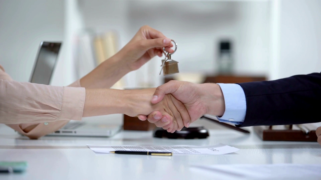 Real estate closing deal handshake with house keys